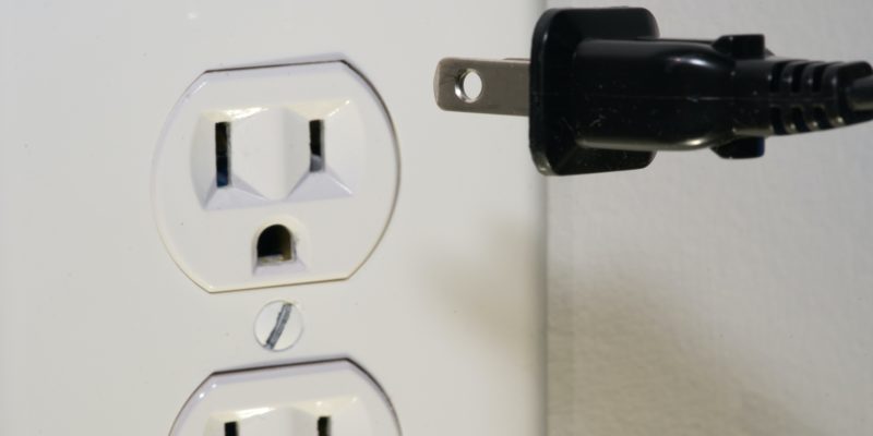 Outlet on a wall with a plug in